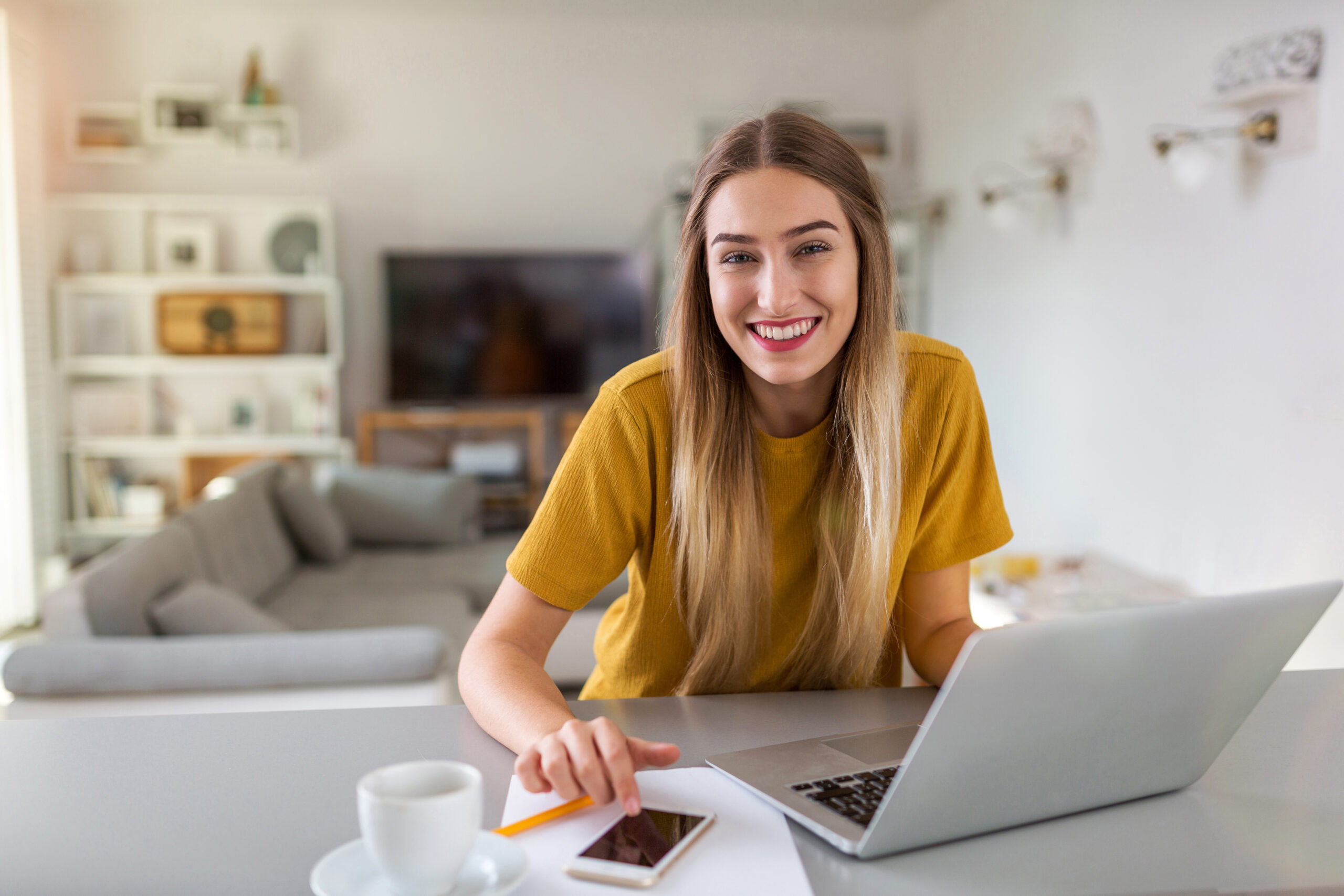 Young woman using her laptop at home